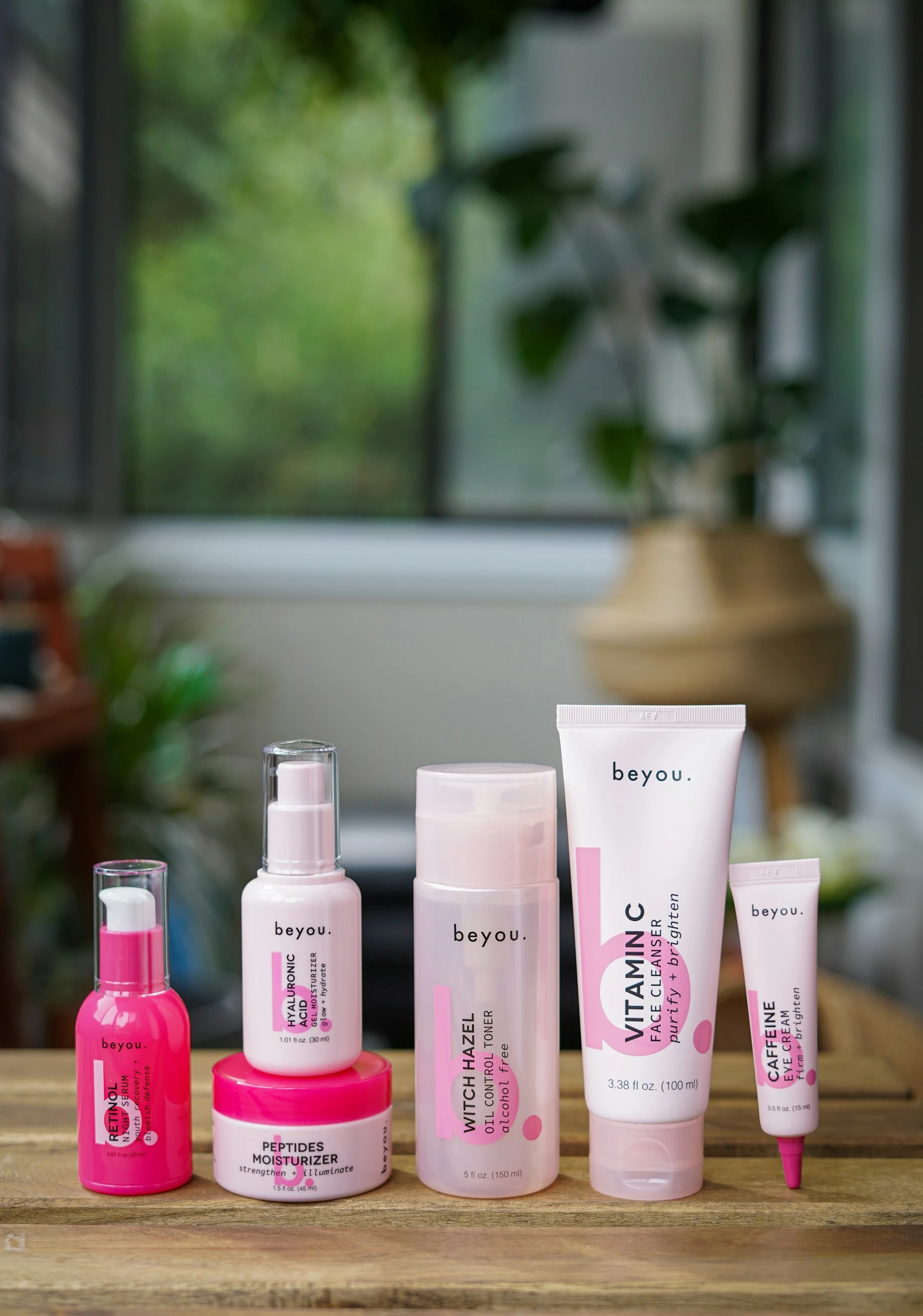 Real skincare-packaging photograph by Alexandra Tran. Brands pictured are context, not products tested by JUYI.